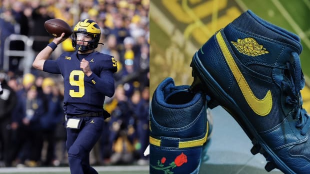 Michigan Wolverines quarterback J.J. McCarthy next to his navy Air Jordan cleats.